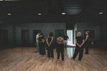 Wide view of the dancers gathered in the studio
