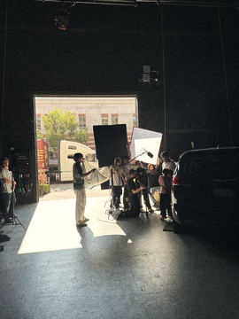 Wide view of the dark soundstage with the crew in the doorway light