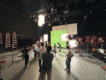 Crew walking the floor in front of the green screen
