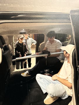 Crew fitting the camera rig through the open car doors