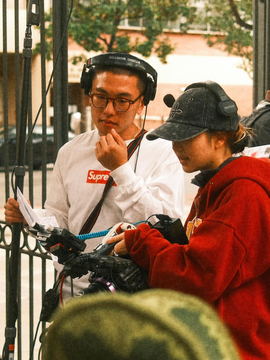Two crew members in headsets conferring at a gate
